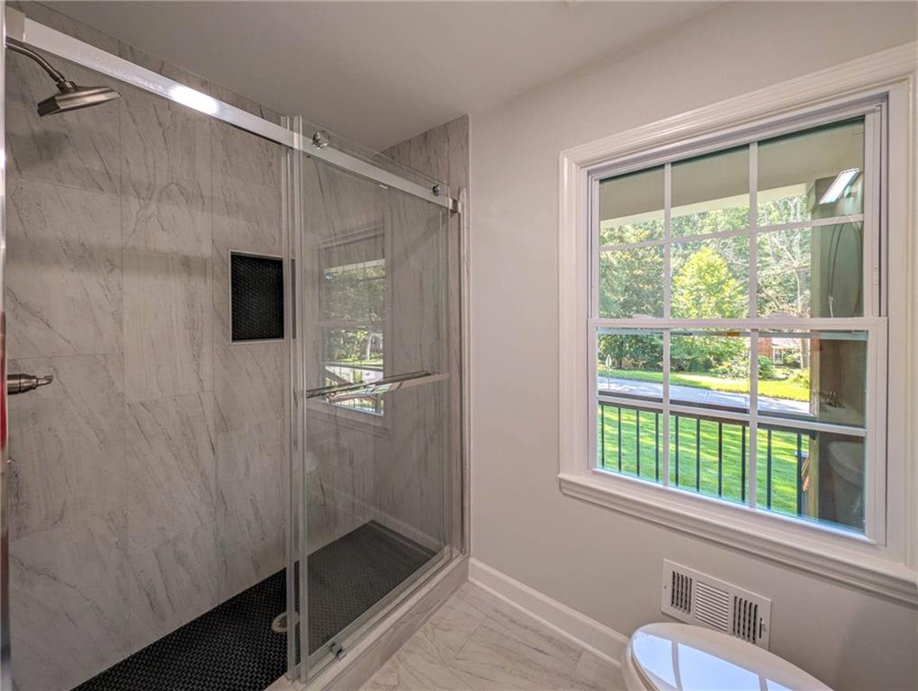 610 Glenforest Road Atlanta, GA 30328 - Photo 27 of 44 a bathroom with a shower and a sink