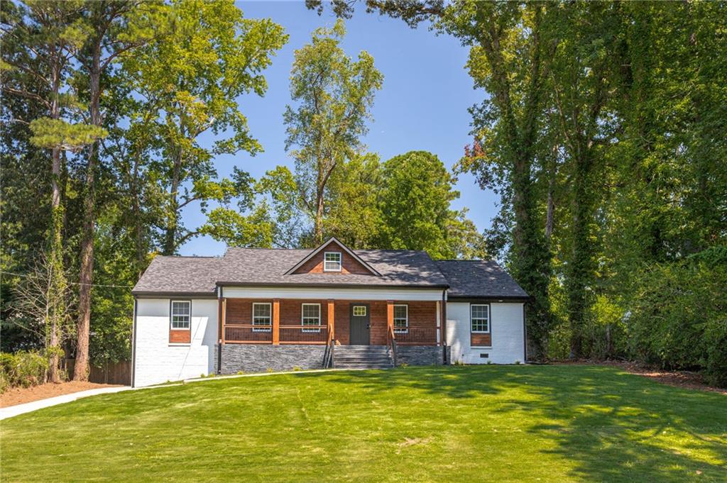 610 Glenforest Road Atlanta, GA 30328 - Photo 3 of 44 a front view of a house with a yard