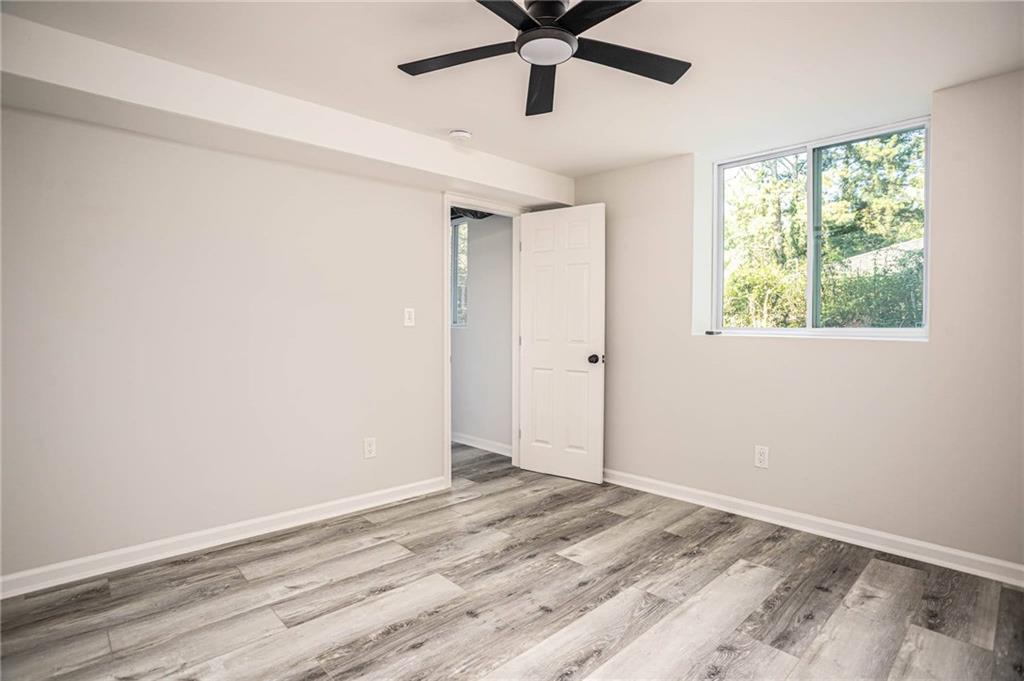 610 Glenforest Road Atlanta, GA 30328 - Photo 36 of 44 a view of a livingroom with wooden floor and a ceiling fan
