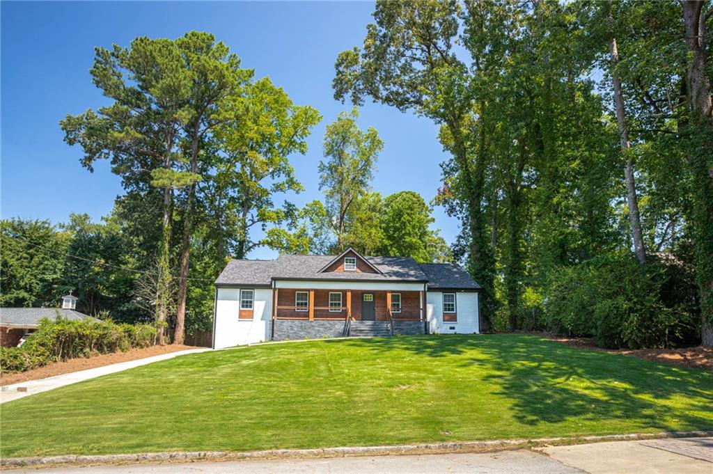 610 Glenforest Road Atlanta, GA 30328 - Photo 4 of 44 a front view of a house with a garden