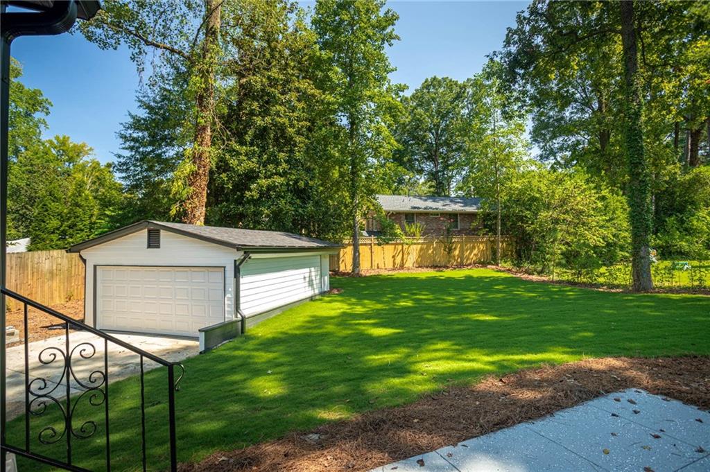 610 Glenforest Road Atlanta, GA 30328 - Photo 41 of 44 a view of a backyard with a garden and tree