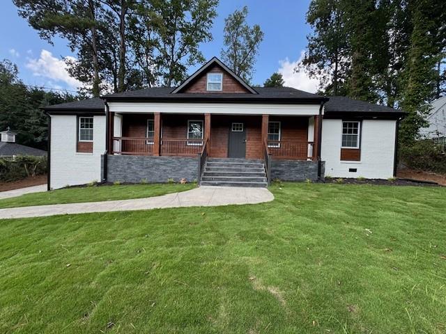 610 Glenforest Road Atlanta, GA 30328 - Photo 5 of 44 a front view of a house with a garden and yard