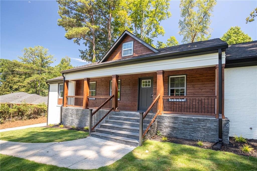 610 Glenforest Road Atlanta, GA 30328 - Photo 6 of 44 a front view of a house with a yard