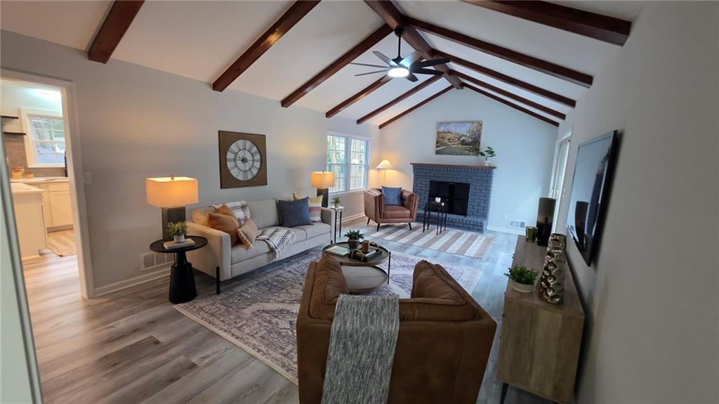 610 Glenforest Road Atlanta, GA 30328 - Photo 10 of 44 a living room with furniture and a fireplace