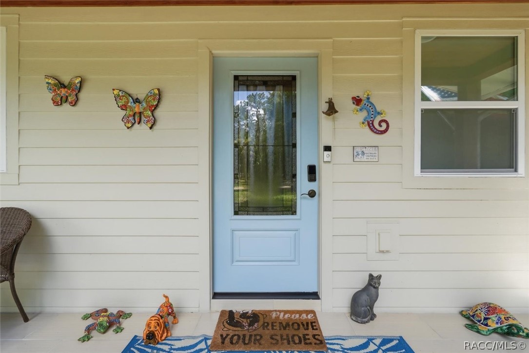 4099 West Ridge Court Dunnellon, FL 34433 - Photo 11 of 49 Nice Covered front porch with hardy Board siding and concrete floors. Great place to sit and enjoy nature!