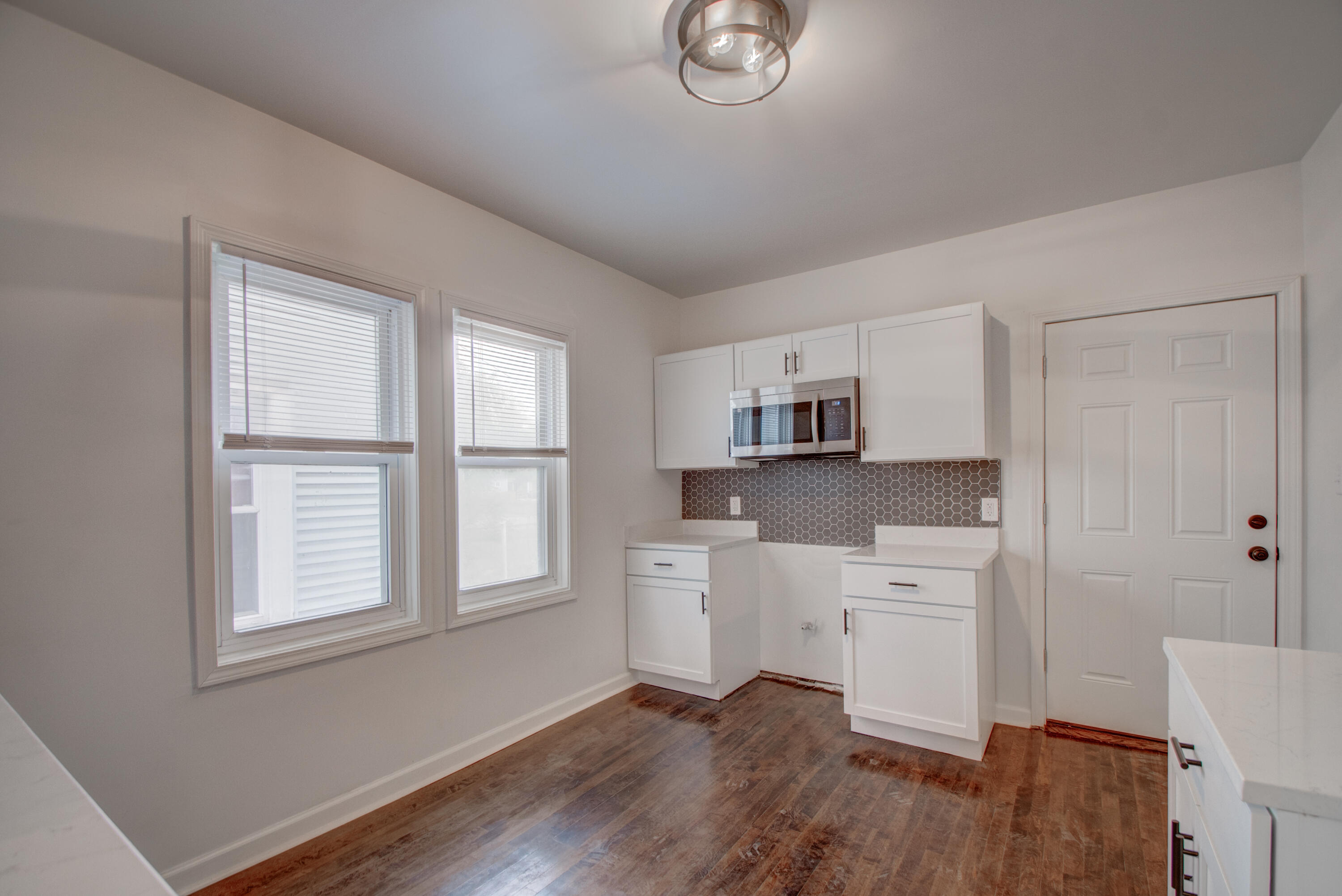613 Tennessee Street Gary, IN 46402 - Photo 22 of 39 a room with stainless steel appliances wooden floors and white walls