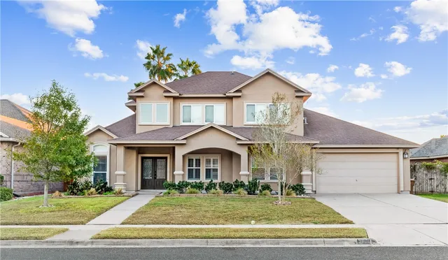 a front view of a house with a yard