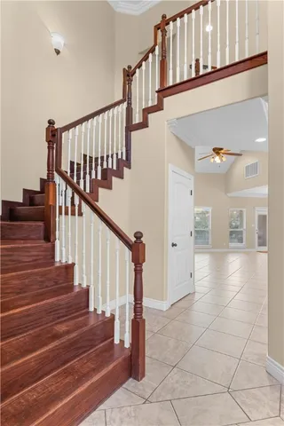 a view of staircase with railing and a rug