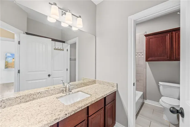 a view of a hallway with a bathroom