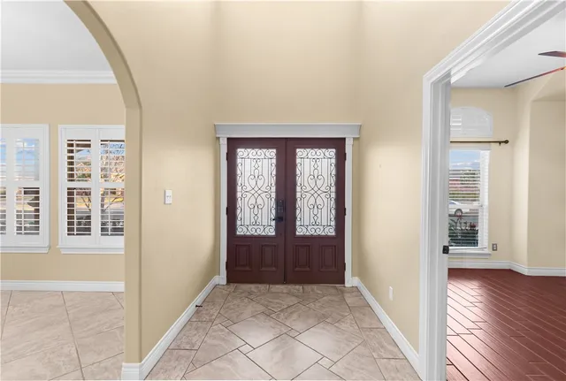 a view of an empty room with a fireplace and a window