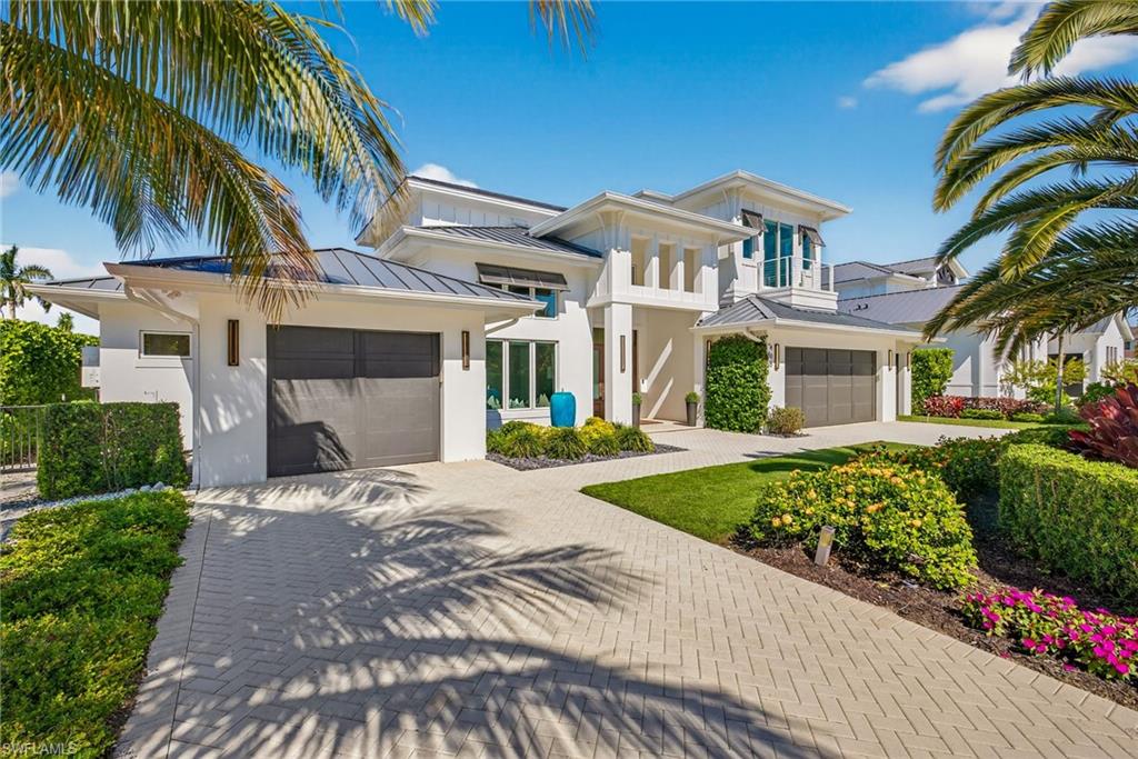405 7th Avenue North Naples, FL 34102 - Photo 1 of 50 a front view of a house with a garden