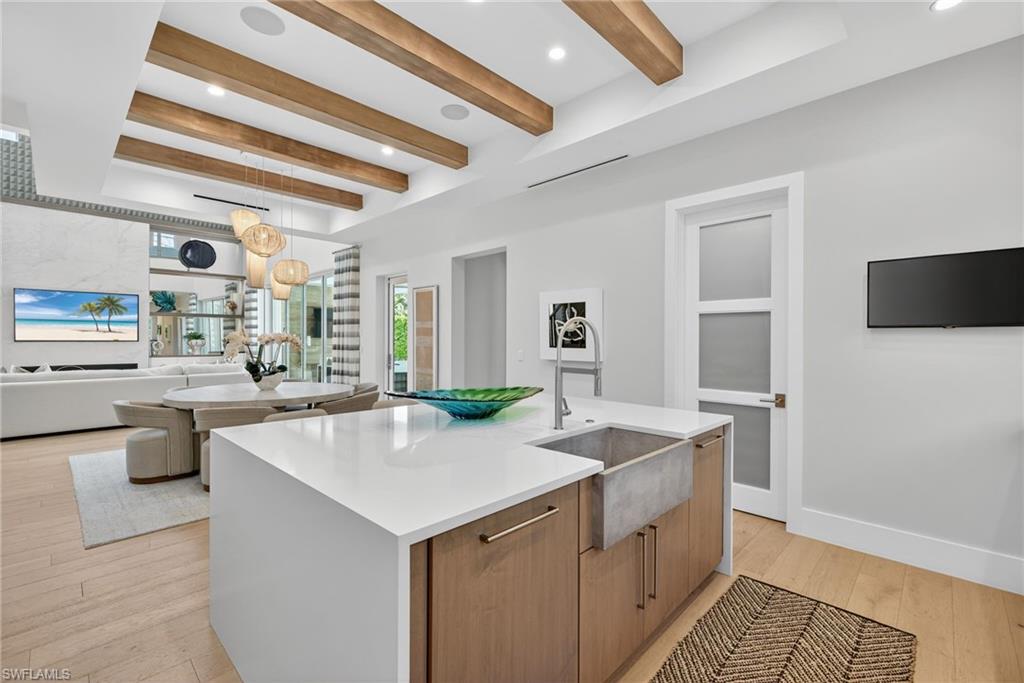 405 7th Avenue North Naples, FL 34102 - Photo 11 of 50 a kitchen with a sink a counter top space and appliances