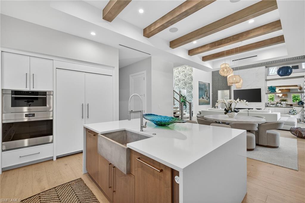 405 7th Avenue North Naples, FL 34102 - Photo 12 of 50 a kitchen with stainless steel appliances kitchen island granite countertop a stove and a sink
