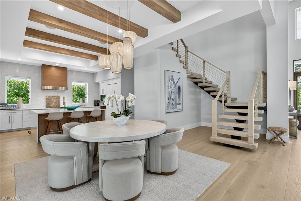 405 7th Avenue North Naples, FL 34102 - Photo 14 of 50 a dining room with furniture and wooden floor