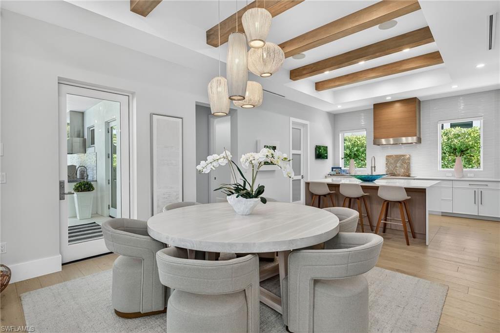 405 7th Avenue North Naples, FL 34102 - Photo 15 of 50 a view of a dining room with furniture window and wooden floor