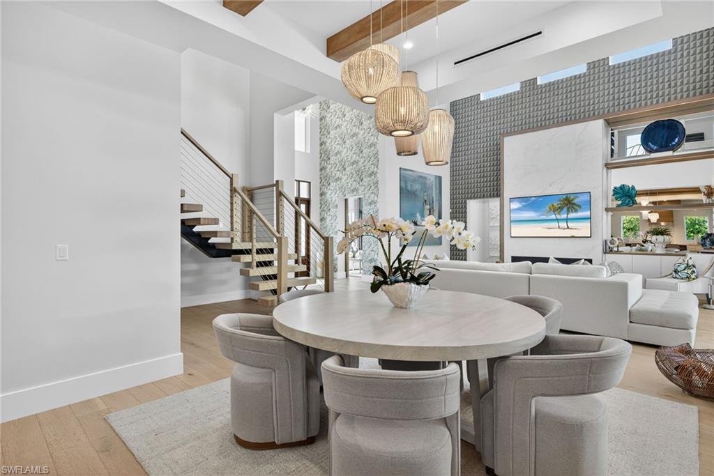 405 7th Avenue North Naples, FL 34102 - Photo 16 of 50 a dining room with furniture and wooden floor
