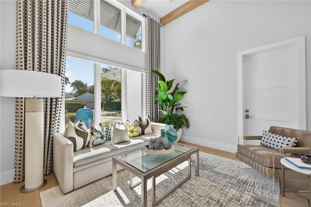 405 7th Avenue North Naples, FL 34102 - Photo 17 of 50 a living room with furniture and a potted plant