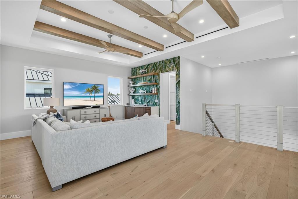405 7th Avenue North Naples, FL 34102 - Photo 25 of 50 a living room with furniture and a flat screen tv