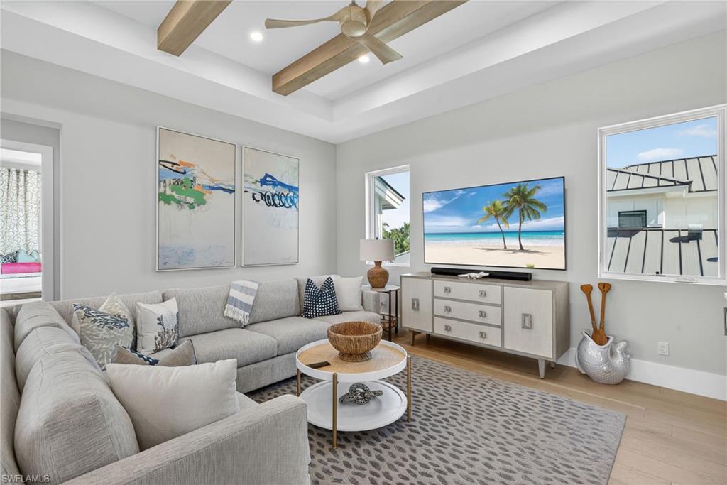 405 7th Avenue North Naples, FL 34102 - Photo 27 of 50 a living room with furniture and a flat screen tv