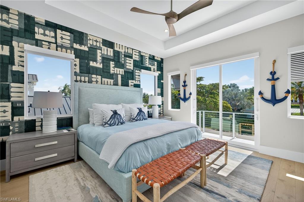 405 7th Avenue North Naples, FL 34102 - Photo 29 of 50 a bedroom with a bed wooden floor and window