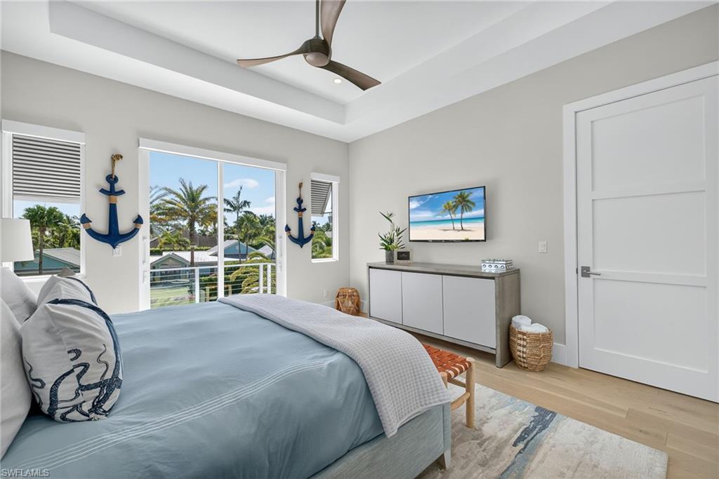 405 7th Avenue North Naples, FL 34102 - Photo 30 of 50 a bedroom with a bed and a large window