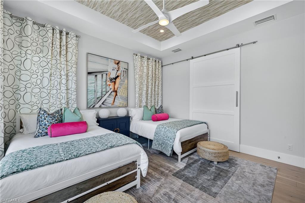 405 7th Avenue North Naples, FL 34102 - Photo 32 of 50 a bedroom with two beds and a potted plant