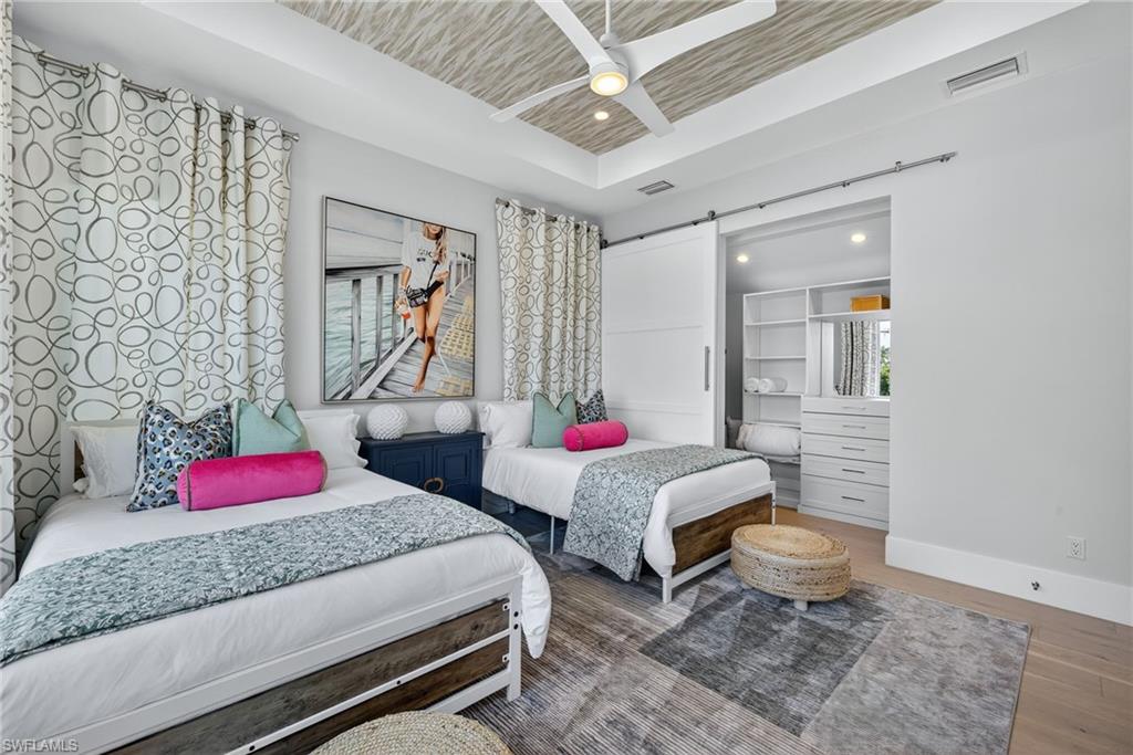 405 7th Avenue North Naples, FL 34102 - Photo 33 of 50 a bedroom with two beds and a potted plant