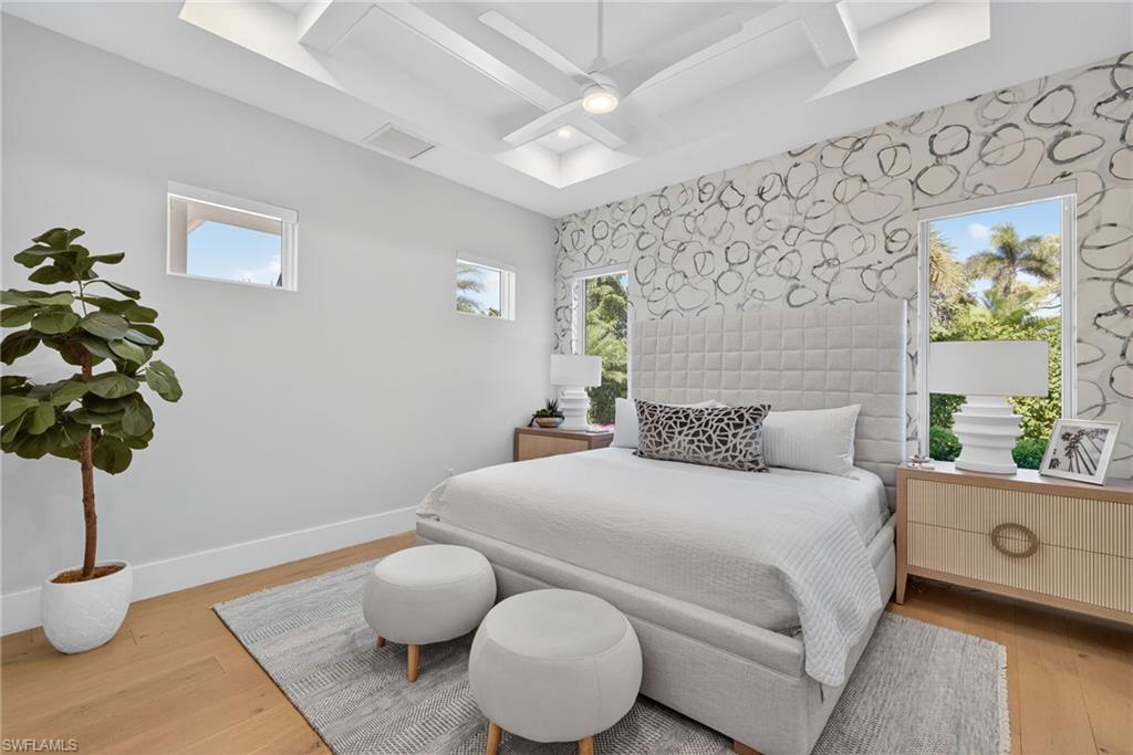 405 7th Avenue North Naples, FL 34102 - Photo 36 of 50 a bedroom with a bed and a chandelier