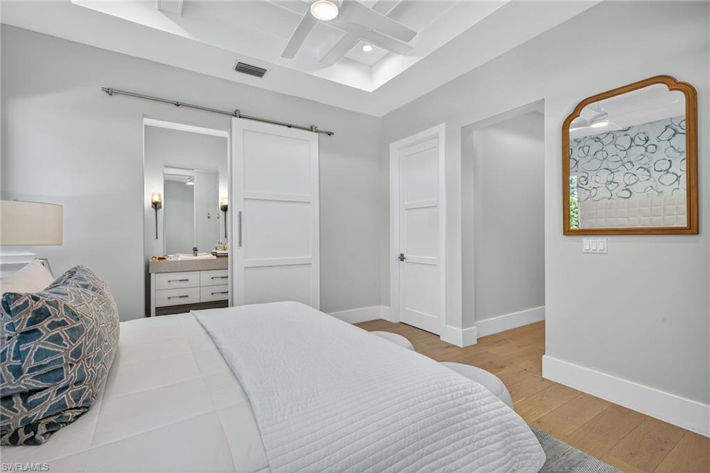 405 7th Avenue North Naples, FL 34102 - Photo 37 of 50 a bedroom with a bed and a painting on the wall
