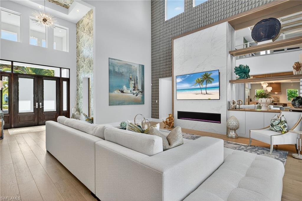 405 7th Avenue North Naples, FL 34102 - Photo 4 of 50 a living room with furniture and a large window