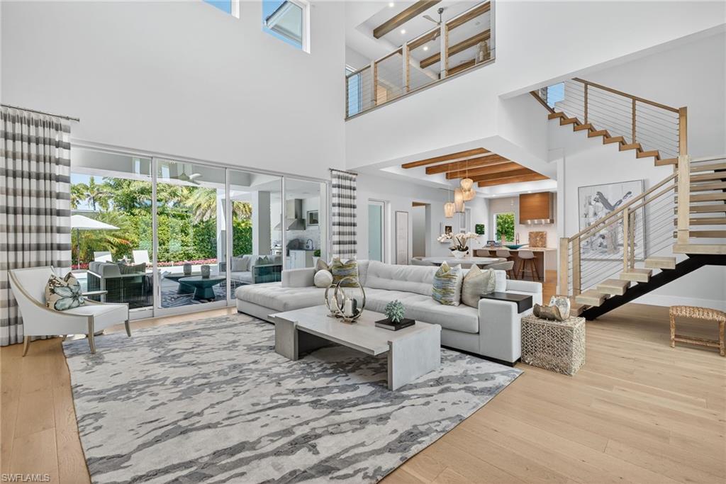 405 7th Avenue North Naples, FL 34102 - Photo 6 of 50 a living room with fireplace furniture and a large window