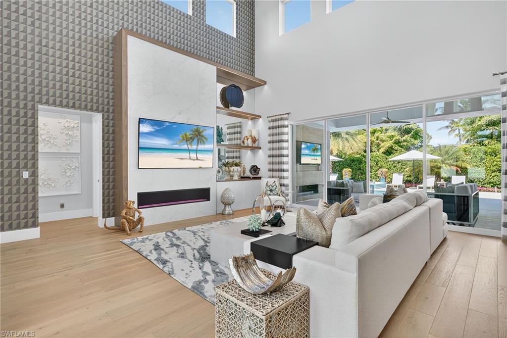 405 7th Avenue North Naples, FL 34102 - Photo 7 of 50 a living room with furniture and a large window