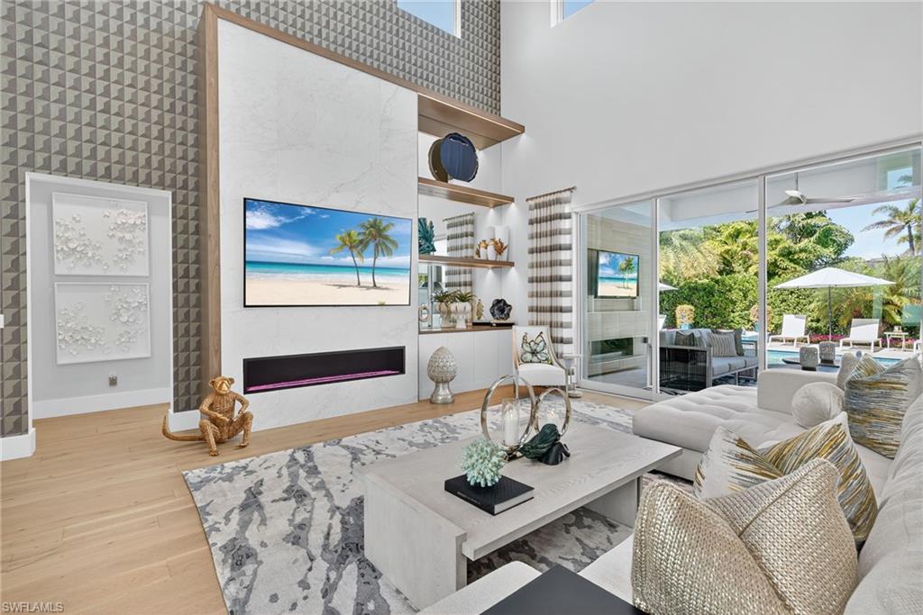405 7th Avenue North Naples, FL 34102 - Photo 8 of 50 a living room with furniture a rug and white walls