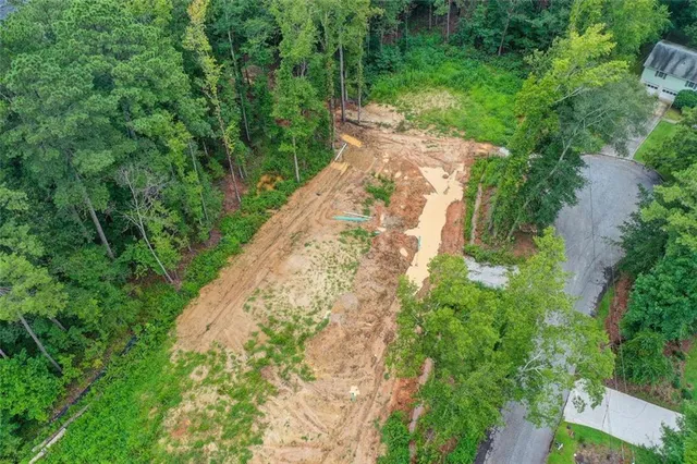 a view of a house with a yard patio and swimming pool