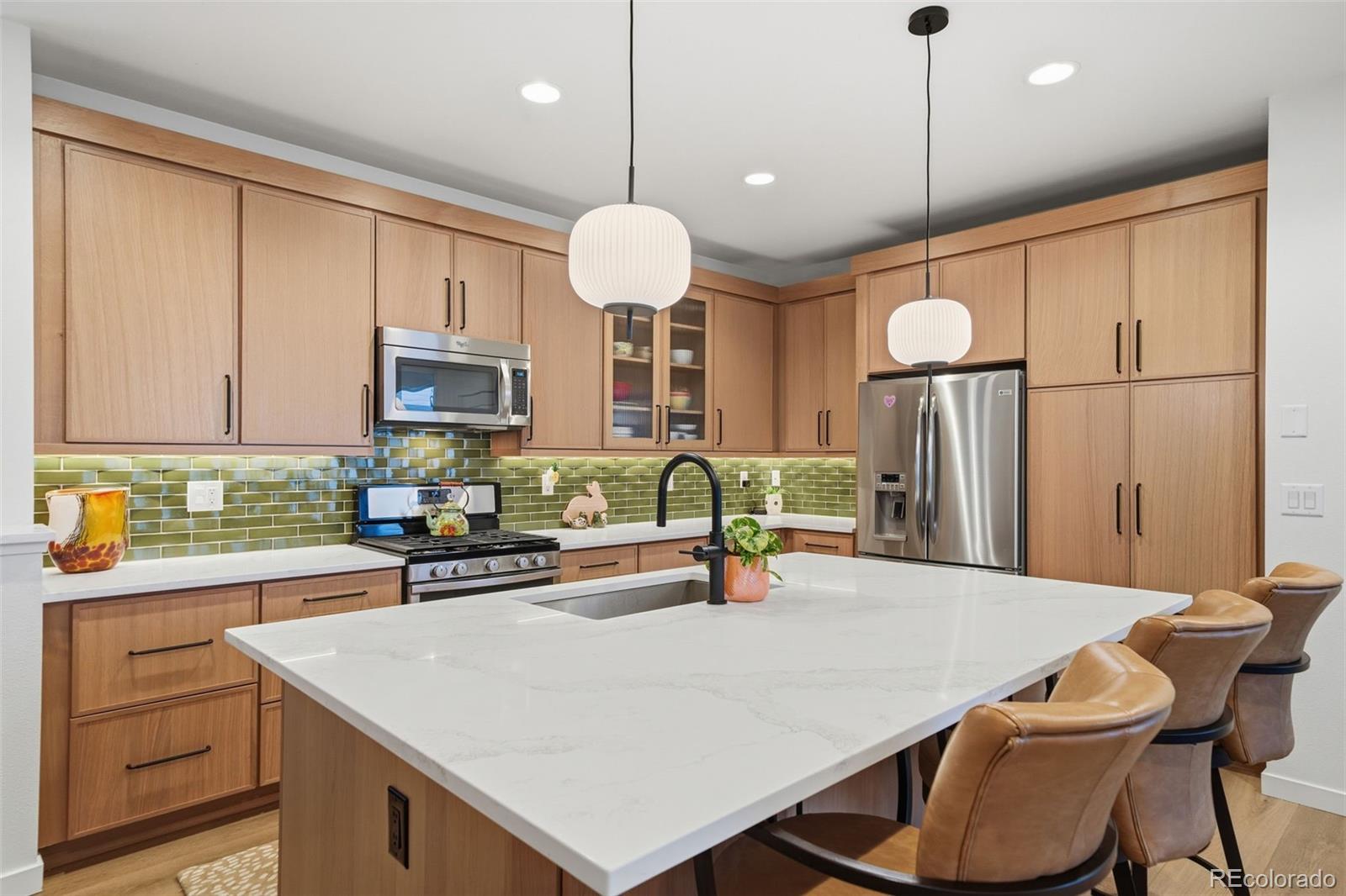 9602 Dunning Circle Highlands Ranch, CO 80126 - Photo 21 of 50 a kitchen with a table chairs and a refrigerator