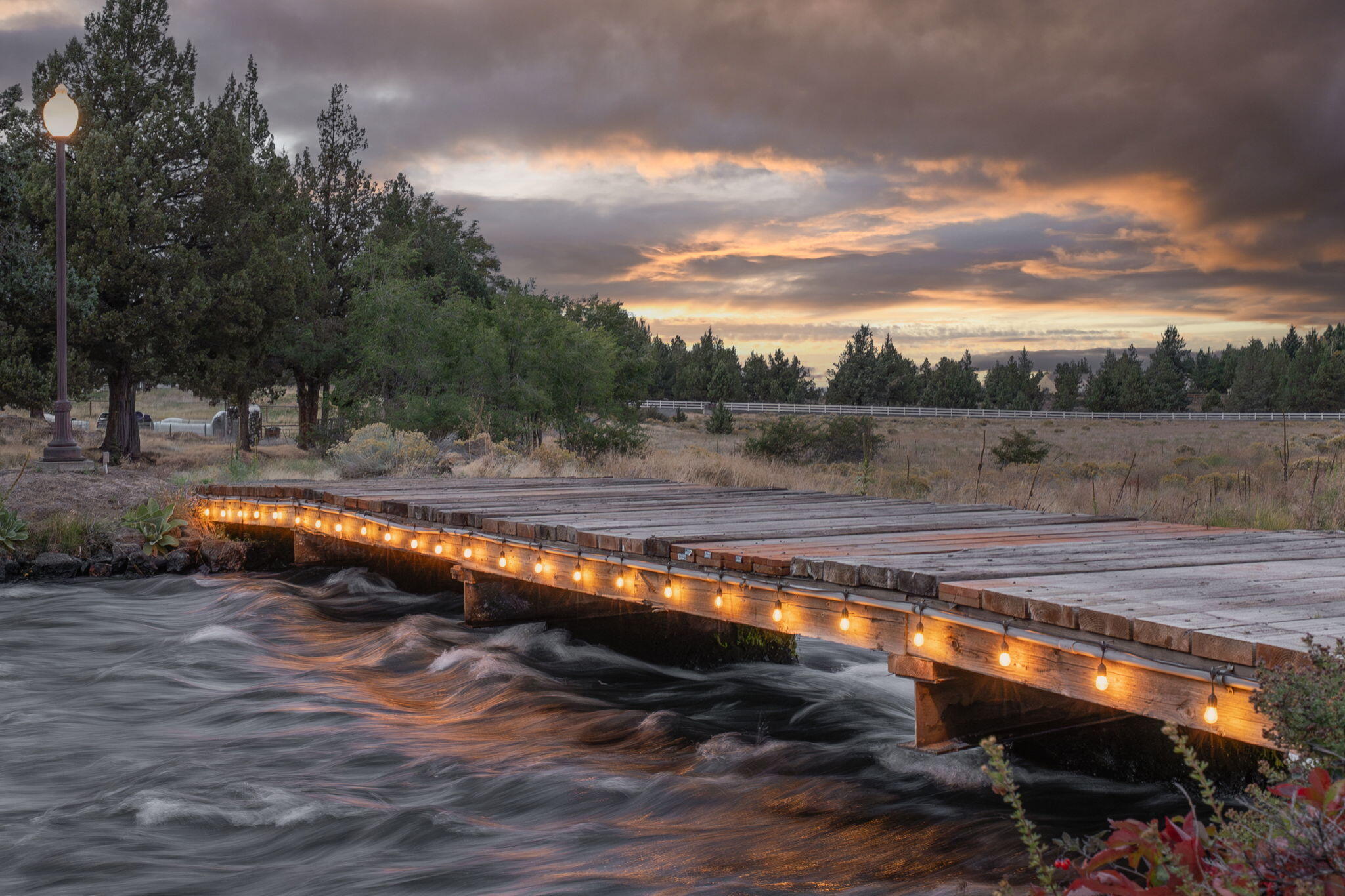 21925 Bear Creek Road Bend, OR 97702 - Photo 93 of 104 Bridge over the rapids of the canal lit up at night