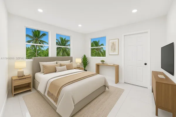 a bedroom with a bed and a flat tv screen on dresser