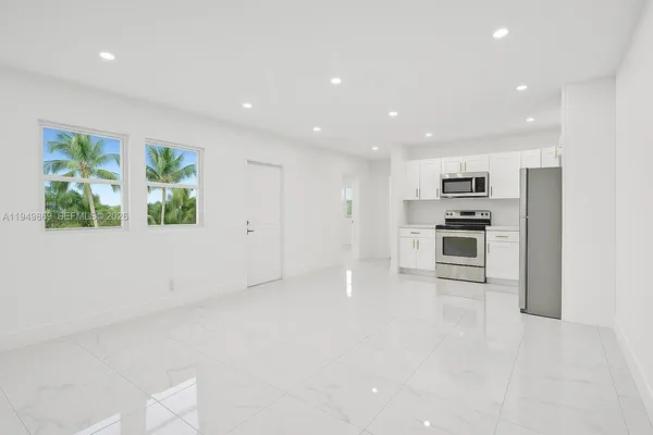 a view of kitchen with stainless steel appliances a refrigerator and a stove top oven