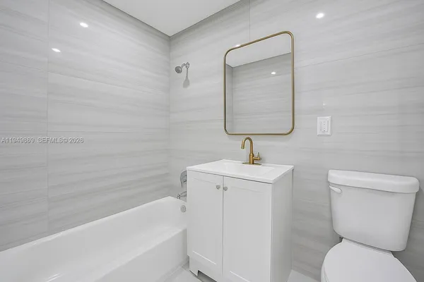 a bathroom with a toilet sink and bathtub