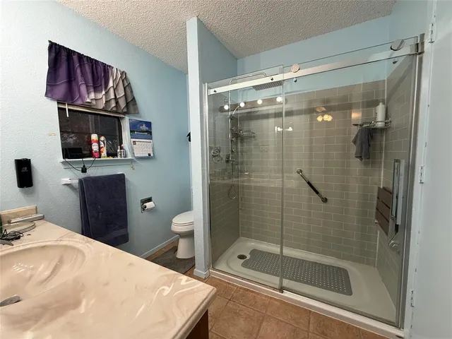 a bedroom with a bed and dresser with mirror