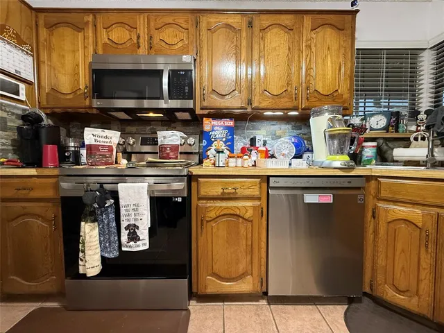a kitchen with a cabinets and appliances