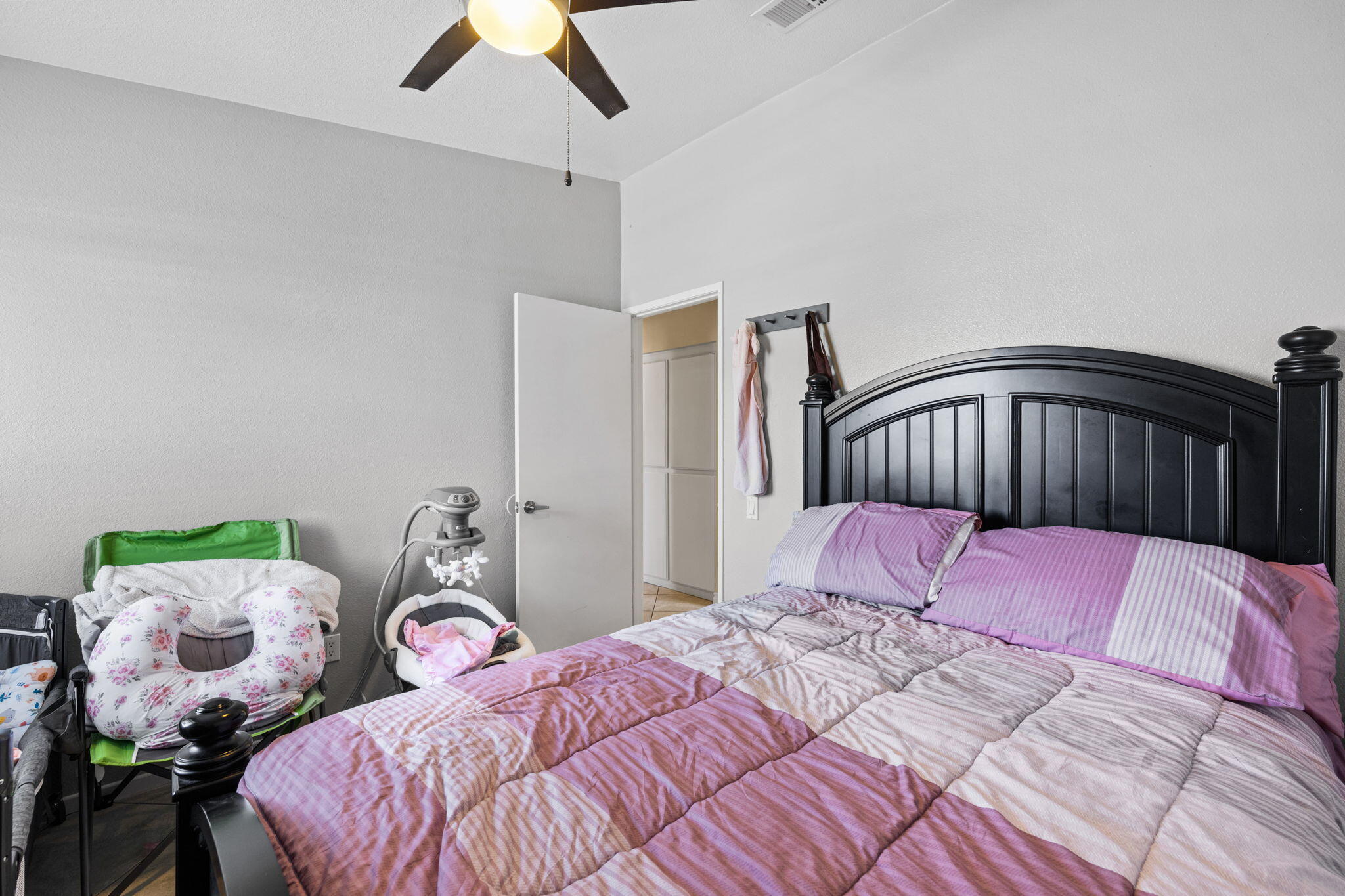 82445 Arlene Drive Indio, CA 92201 - Photo 13 of 18 a bedroom with a bed and a chandelier