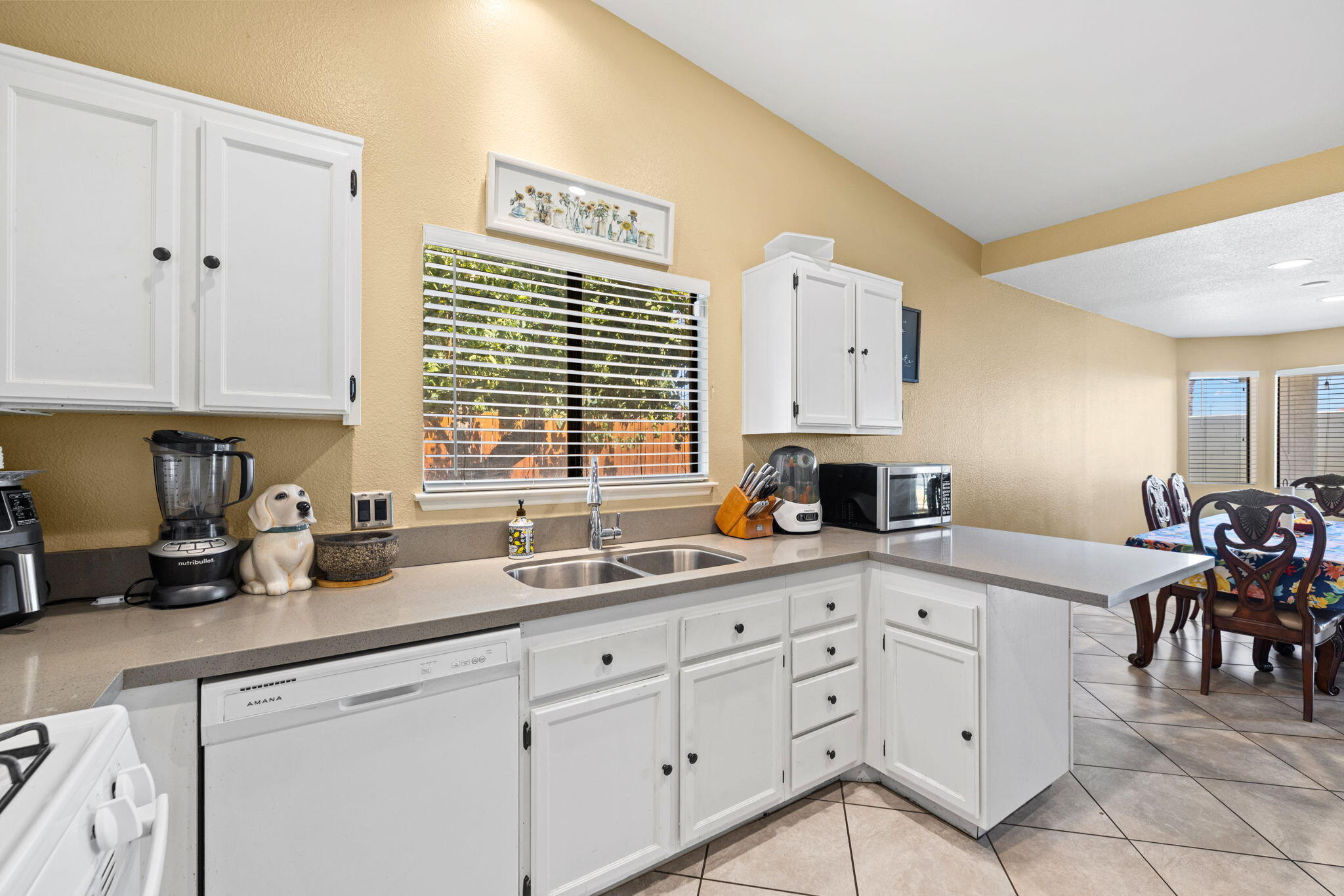 82445 Arlene Drive Indio, CA 92201 - Photo 5 of 18 a kitchen with cabinets appliances and a window