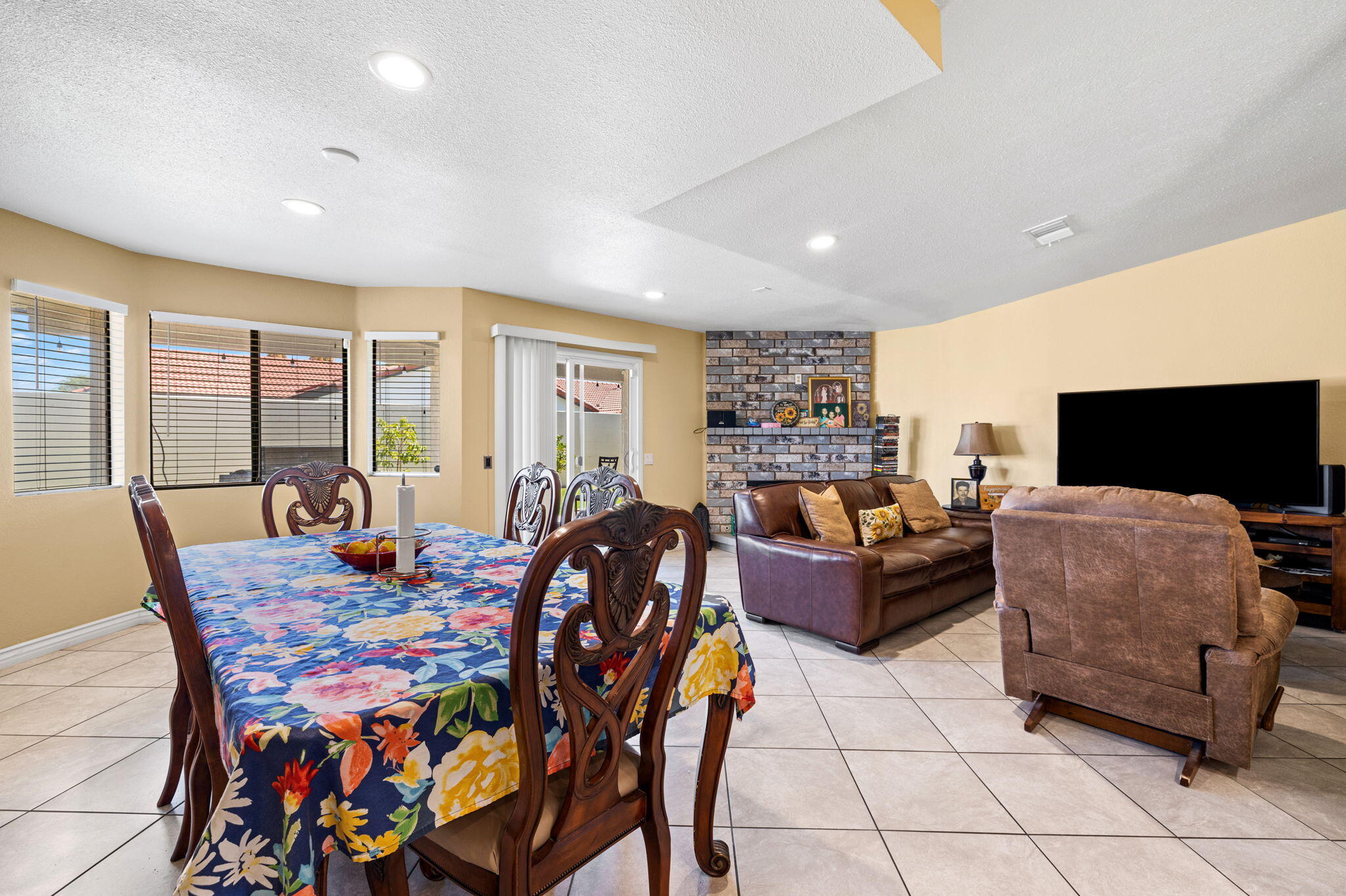 82445 Arlene Drive Indio, CA 92201 - Photo 6 of 18 a living room with furniture a flat screen tv and a large window