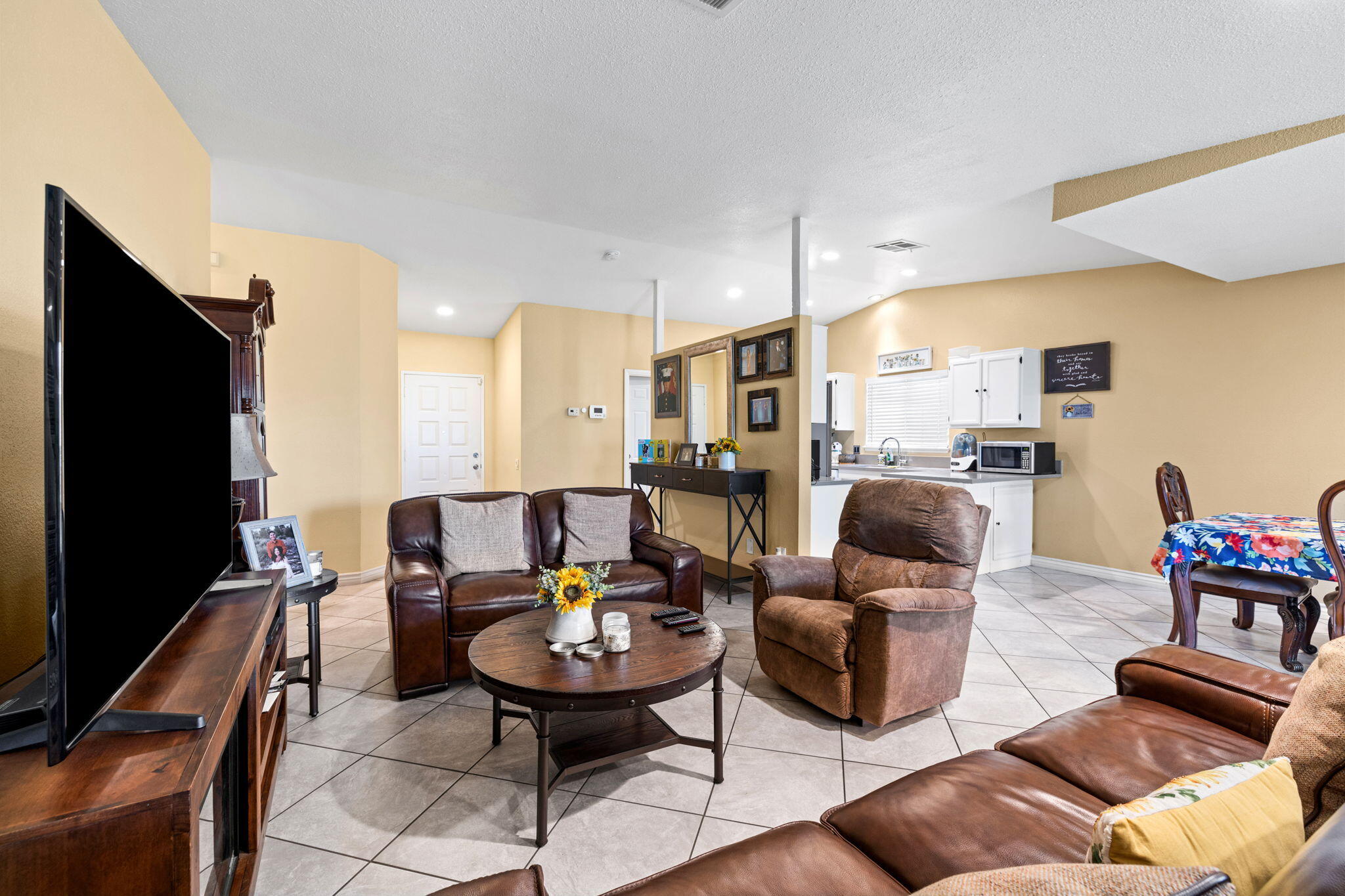 82445 Arlene Drive Indio, CA 92201 - Photo 9 of 18 a living room with furniture kitchen view and a flat screen tv