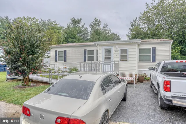 a view of a house with a bed and a chairs