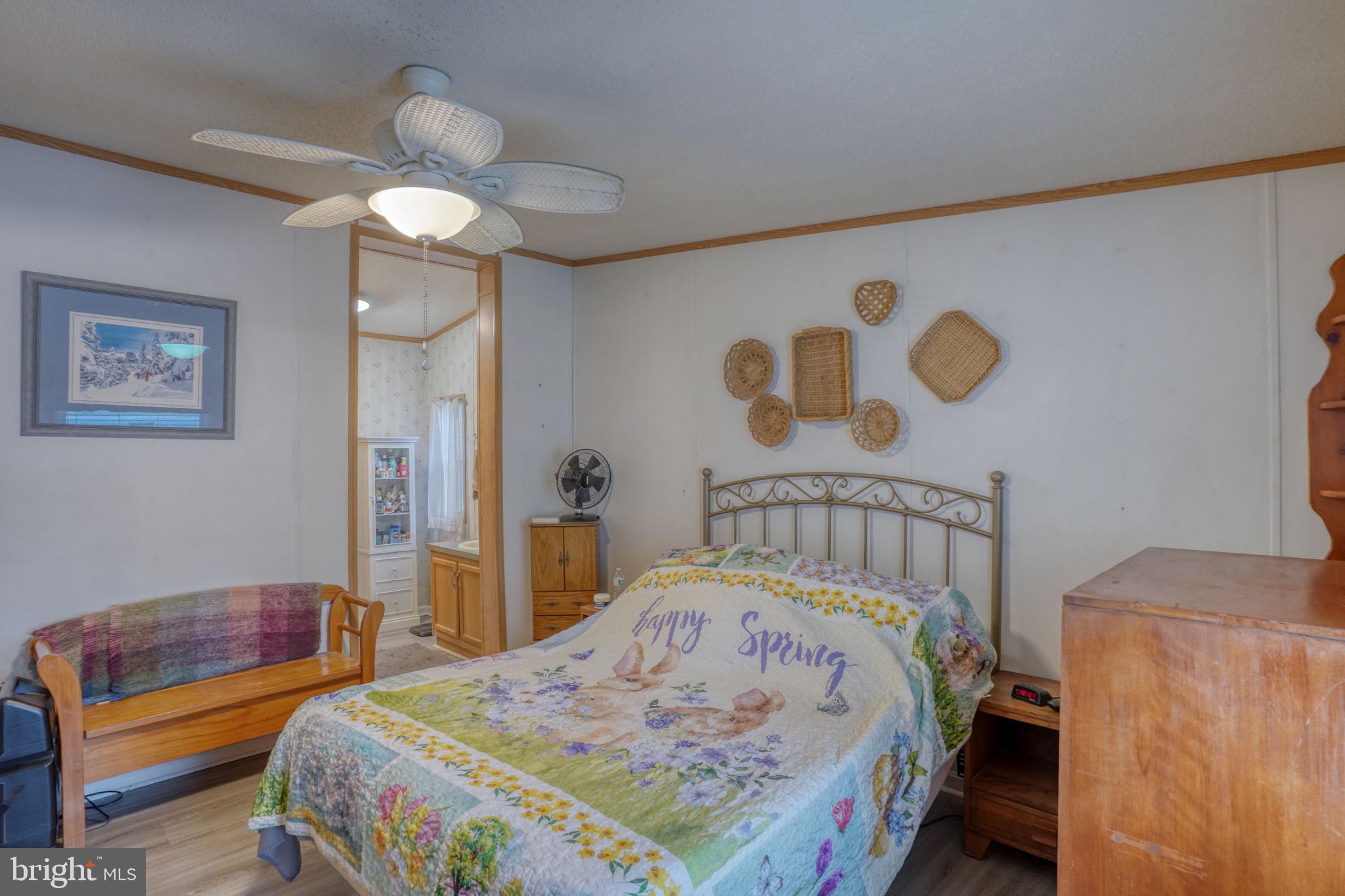 1679 South State Street, Unit A55 Dover, DE 19901 - Photo 14 of 26 a bedroom with a bed and a chandelier