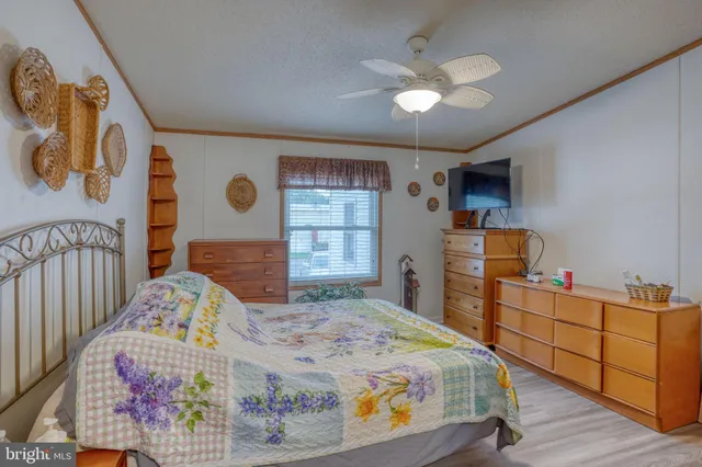 a bedroom with a bed and a dresser in it