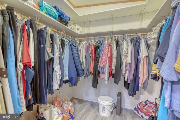 a view of walk in closet with clothes