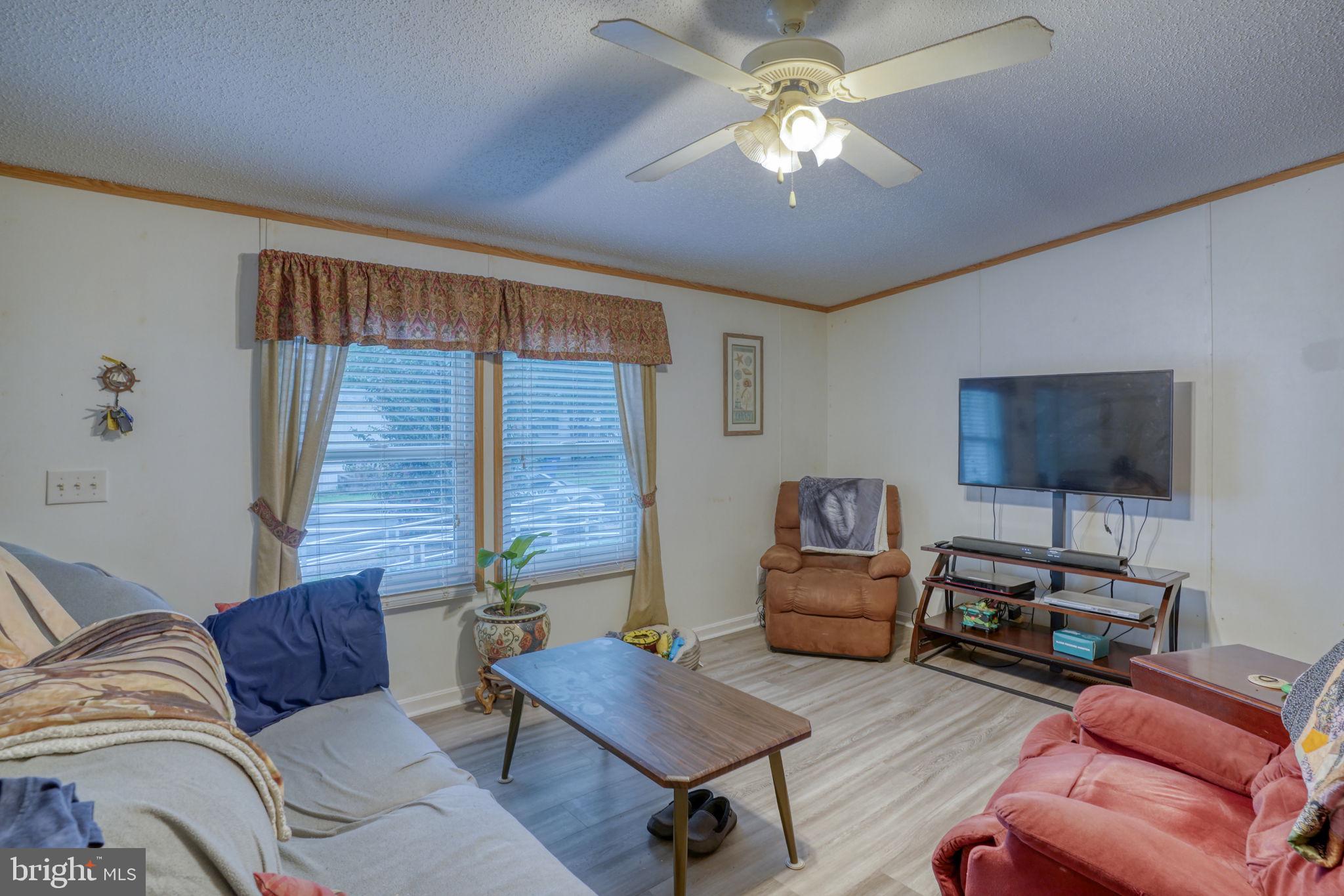 1679 South State Street, Unit A55 Dover, DE 19901 - Photo 2 of 26 a living room with furniture and a flat screen tv